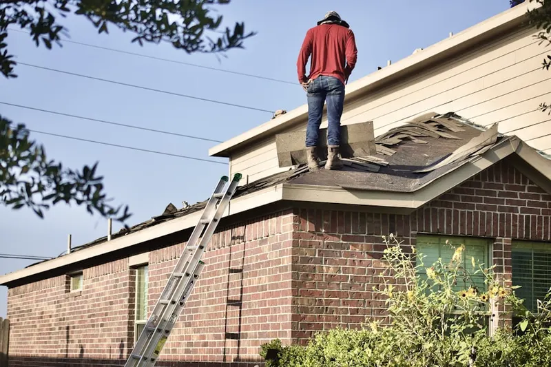Professional roofer working on a residential roof in Cassel Mill Farms